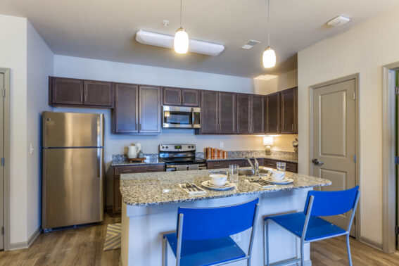 Furnished apartment kitchen featuring stainless steel appliances